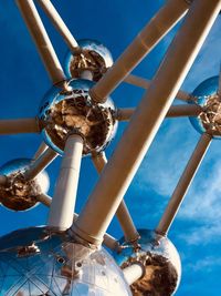 Low angle view of chain swing ride against clear blue sky