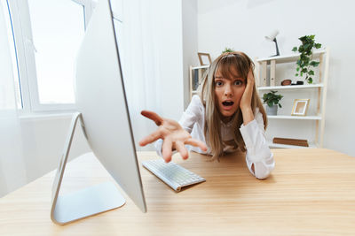 Portrait of young businesswoman working at table