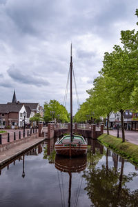 View of river by building against sky