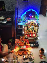 High angle view of illuminated statues in store