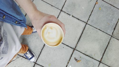 Low section of woman with coffee cup