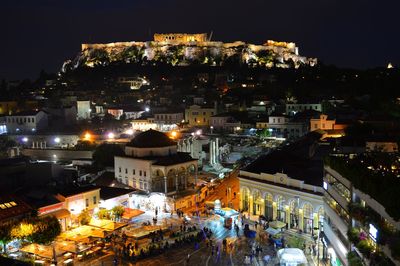 High angle view of city lit up at night