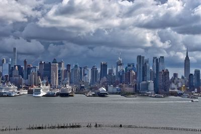 View of cityscape against cloudy sky