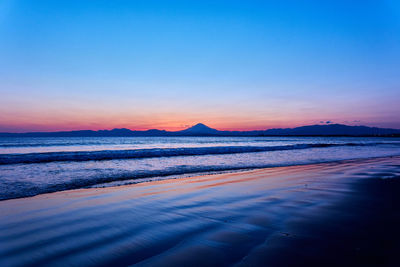 Scenic view of sea against romantic sky during sunset