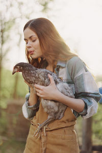 Young woman holding bird