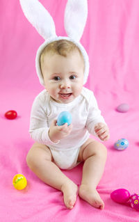 Portrait of cute baby boy playing with toys on table