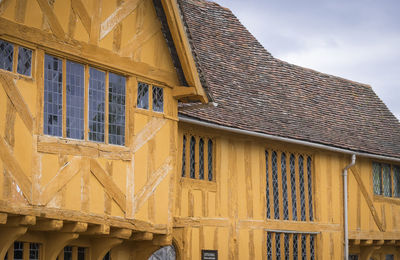 Low angle view of yellow building against sky in suffolk