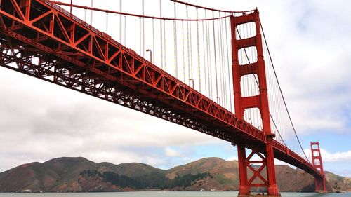 Low angle view of golden gate bridge against sky