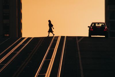 Silhouette of man on road against sky