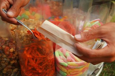 Close-up of cropped hand holding ice cream