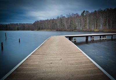 Pier over lake against sky