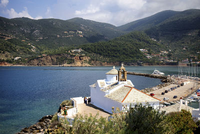 High angle view of buildings by sea against sky