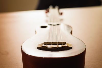 Close-up of ukulele on wooden table