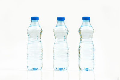 Close-up of wine bottles against white background