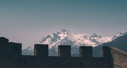 Scenic view of snowcapped mountains against clear sky