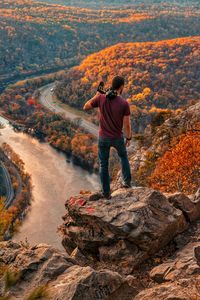 Rear view of man standing on rock