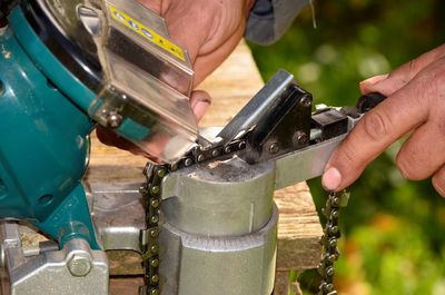 Close-up of man working on metal