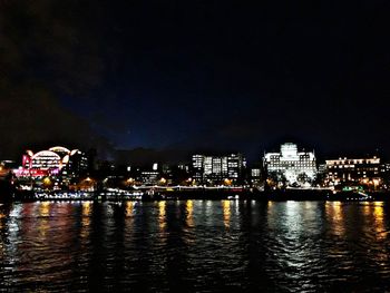 Illuminated city at waterfront