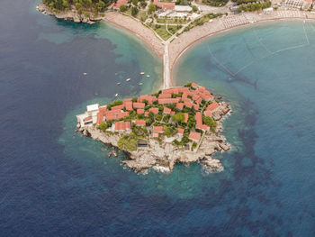 High angle view of swimming pool by sea against buildings