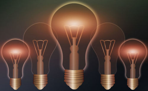 Digital composite image of illuminated light bulb