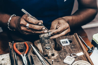 Midsection of man working at workshop