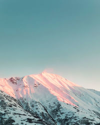 Scenic view of snowcapped mountains against clear sky