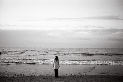 The girl is standing on the beach