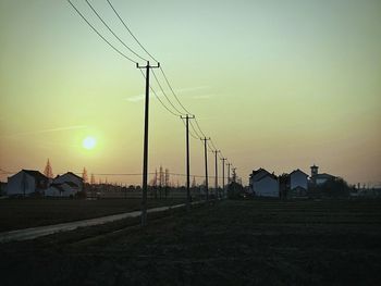 Electricity pylon against sky during sunset