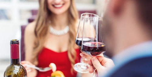 Midsection of a woman drinking glass