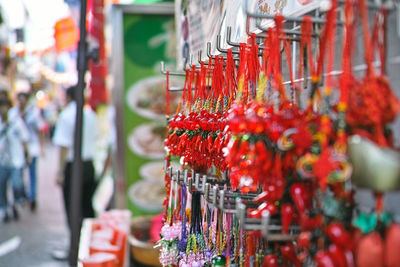 Close-up of craft products hanging at market stall