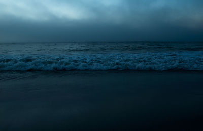 Scenic view of sea against sky at sunset