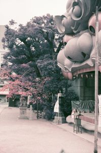 Statue amidst plants and buildings in yard