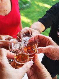 Midsection of people holding drinks