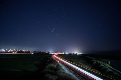 High angle view of moving train against sky at night