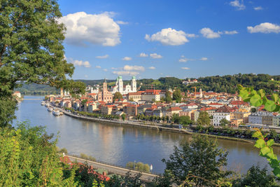 High angle view of river by city against sky