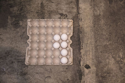 High angle view of egg carton on old table