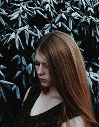 Close-up of woman standing against plant during winter