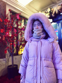 Portrait of young woman standing outdoors