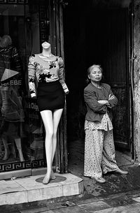 Portrait of woman standing in front of building