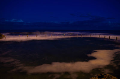 Scenic view of beach against sky at night