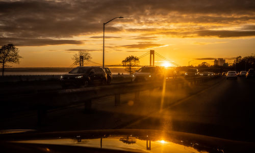 Light trails on road against sky during sunset