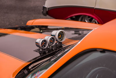 Close-up of speedometer on orange car