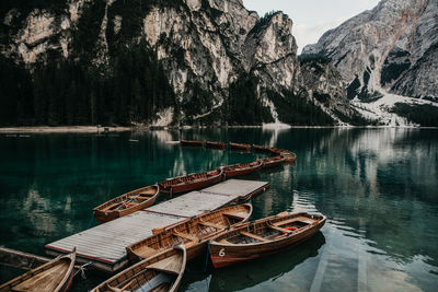 Boat moored on lake against mountain