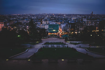 High angle view of city lit up at night