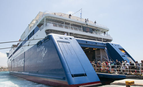 Ship moored at harbor against sky