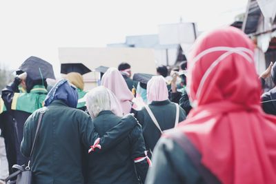 Rear view of people walking on street