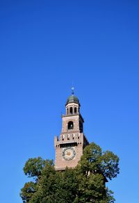 Low angle view of clock tower against clear blue sky