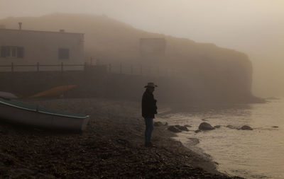 Adult man with fishing boat on port during sunrise. almeria, spain