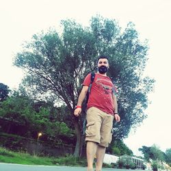 Portrait of young man against trees