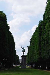 Statue of plants against cloudy sky
